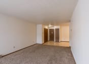 Thumbnail 6 of 16 - an empty living room with carpet and white walls. Moorhead, MN South Park Apartments