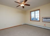 Thumbnail 5 of 21 - a bedroom with a window and a ceiling fan. Fargo, ND Crossroads Apartments