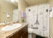 Thumbnail 25 of 34 - a bathroom with a shower curtain with the eiffel tower. Fargo, ND Islander Apartments