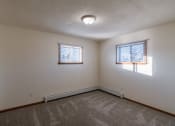 Thumbnail 13 of 16 - a bedroom with two windows. Fargo, ND North Manor Apartments