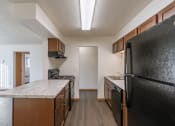 Thumbnail 11 of 16 - a kitchen and living room. Fargo, ND North Manor Apartments