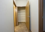 Thumbnail 8 of 23 - a hallway with a closet with shelves and a door open. Fargo, ND North Sky Apartments