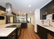 Thumbnail 19 of 30 - The Edge of Uptown Apartments | Community Room Kitchen with sink and stove