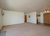 Thumbnail 6 of 11 - Living room of an empty house with white walls and a beige carpet, Oak Court Apartments, ND 58103