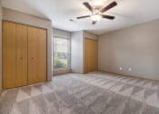 Thumbnail 11 of 21 - Omaha, NE Beacon Hill Apartments. An empty bedroom with a ceiling fan