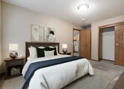 Thumbnail 3 of 10 - Omaha, NE Deerfield Apartments. A bedroom with a bed and a door to a bathroom