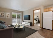 Thumbnail 1 of 10 - Omaha, NE Deerfield Apartments. A living room with a couch coffee table and a television