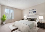 Thumbnail 7 of 34 - Omaha, NE Evergreen Terrace Apartments. Bedroom with a large white bed and a large window