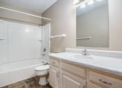 Thumbnail 20 of 23 - Omaha, NE Maple Ridge Apartments. A bathroom with a sink toilet and bathtub