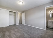 Thumbnail 9 of 23 - Omaha, NE Maple Ridge Apartments. A bedroom with a bathroom and a closet