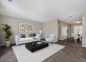 Thumbnail 1 of 23 - Omaha, NE Maple Ridge Apartment. A living room with a white couch and a coffee table