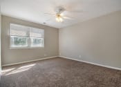 Thumbnail 16 of 23 - Omaha, NE Maple Ridge Apartments. A bedroom with a ceiling fan and two windows