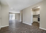 Thumbnail 13 of 23 - Omaha, NE Maple Ridge Apartment. A dining room with a kitchen and livingroom in the background