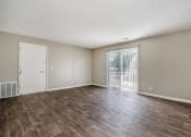Thumbnail 11 of 23 - Omaha, NE Maple Ridge Apartments. A living room with a sliding glass door