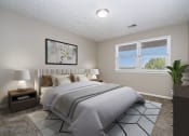 Thumbnail 4 of 23 - Omaha, NE Maple Ridge Apartments. A bedroom with a large bed and a large window