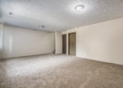 Thumbnail 8 of 29 - Omaha, NE Stony Brook Townhomes.  A spacious living room with carpeted flooring and white walls