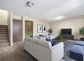 Thumbnail 5 of 29 - Omaha, NE Stony Brook Townhomes. A living room with couches and a tv