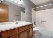 Thumbnail 13 of 27 - Omaha, NE Woodland Pines Apartments. A bathroom with a toilet sink and bathtub