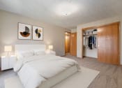 Thumbnail 2 of 27 - Omaha, NE Woodland Pines Apartments. A bedroom with a bed and a wardrobe