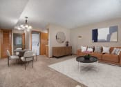 Thumbnail 1 of 27 - Omaha, NE Woodland Pines Apartments. a living room with a couch and a table