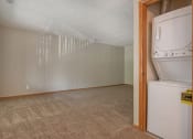 Thumbnail 15 of 27 - Omaha, NE Woodland Pines Apartments. A laundry closet with a washer and dryer