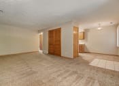 Thumbnail 14 of 27 - Omaha, NE Woodland Pines Apartments. A living room with a couch and a chair