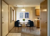 Thumbnail 5 of 27 - a dining room with a white table and blue chairs  at Woodland Pines, Omaha