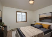Thumbnail 4 of 20 - Fargo, ND Park Circle Apartments. a bedroom with a bed and a dresser