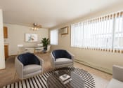 Thumbnail 5 of 20 - Fargo, ND Park Circle Apartments. a living room with two chairs and a coffee table