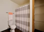 Thumbnail 12 of 25 - Bathroom with a toilet and a shower curtain  at Park Place Apartments in Fargo, 58103