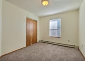 Thumbnail 10 of 25 - Bedroom with carpet and a door to a bedroom at Park Place Apartments in Fargo