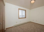 Thumbnail 12 of 20 - the bedroom  with carpet and a window. Fargo, ND Park Circle Apartments.