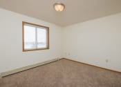 Thumbnail 10 of 20 - A bedroom with a window and a carpeted floorFargo, ND Park Circle Apartments | Kitchen