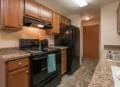 Thumbnail 3 of 6 - Kitchen with Black Appliances at Parkview Arms Apartments in Bismarck, ND
