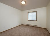 Thumbnail 11 of 15 - A bedroom with a window. Pinehurst Apartments | 2 Bedroom Plan I | Bedroom