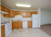 Thumbnail 12 of 15 - A kitchen with white appliances. Pinehurst Apartments | 2 Bedroom Plan D | Kitchen