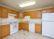 Thumbnail 13 of 15 - A kitchen with white appliances. Pinehurst Apartments | 2 Bedroom Plan D | Kitchen