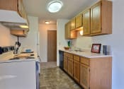 Thumbnail 34 of 36 - A kitchen with white appliances. Fargo, ND Place One Apartments.