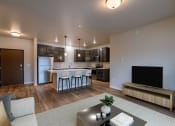 Thumbnail 4 of 26 - a living room with a kitchen and a tv in it. Fargo, ND Prairiewood Meadows Apartments
