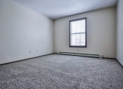 Thumbnail 10 of 25 - Grand Forks Primrose Apartments an empty room with a window and carpet