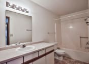 Thumbnail 24 of 25 - Grand Forks Primrose Apartments. A bathroom with a sink and a toilet