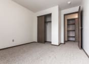 Thumbnail 20 of 25 - Grand Forks Primrose Apartments. An empty bedroom with a closet and an open door