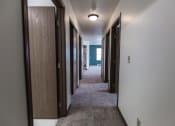 Thumbnail 23 of 25 - Grand Forks Primrose Apartments. A look down the hallway of an apartment with bedrooms and a bathroom
