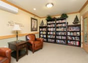 Thumbnail 16 of 21 - a library with comfy chairs and a large bookshelf. Fargo, ND Sunrise North