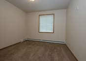 Thumbnail 6 of 25 - an empty bedroom with carpet and a window. Fargo, ND North Sky Apartments