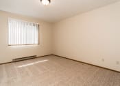 Thumbnail 18 of 28 - Grand Forks, ND Richfield Apartments. A bedroom with a window and carpeted floors