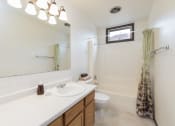 Thumbnail 6 of 10 - Bismarck, ND Riverpark Apartments. A bathroom with a toilet sink and bathtub  Riverpark Apartments | Bismarck, ND