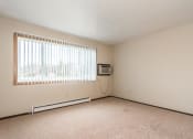 Thumbnail 6 of 23 - Grand Forks, ND Riverwood Apartments. A living room with a window and a television