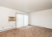 Thumbnail 16 of 23 - Grand Forks, ND Riverwood Apartments. A  living room with a heater and a window