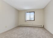 Thumbnail 11 of 41 - an empty room with a window and carpeting. Roseville, MN Rosedale Estates